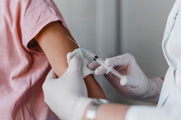 Free photo doctor administering a vaccine to child