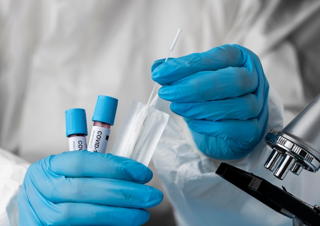 Doctor analyzing blood samples with microscope