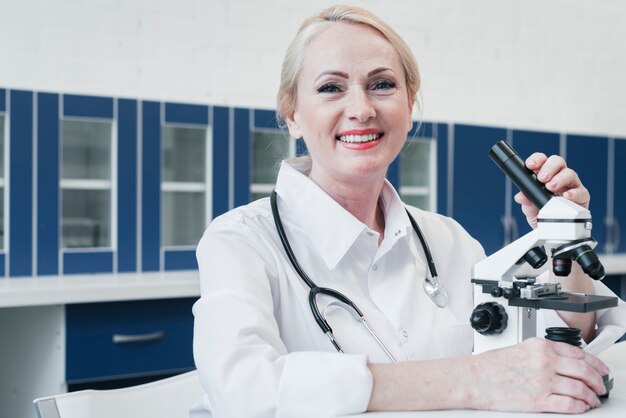 Doctor analyzing with a microscope