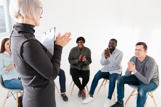 Doctor applauding with rehab patients