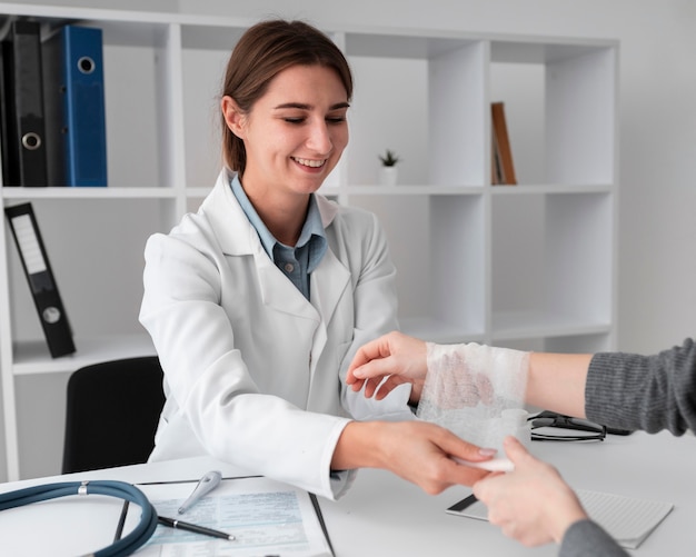 Doctor arranging hand bondage for patient