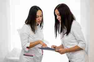 Free photo doctor and assistant checking medical form