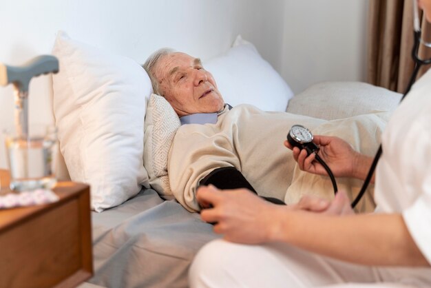 Doctor checking the blood pressure of a male patient