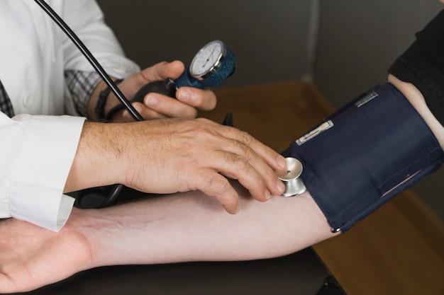 Doctor checking blood pressure