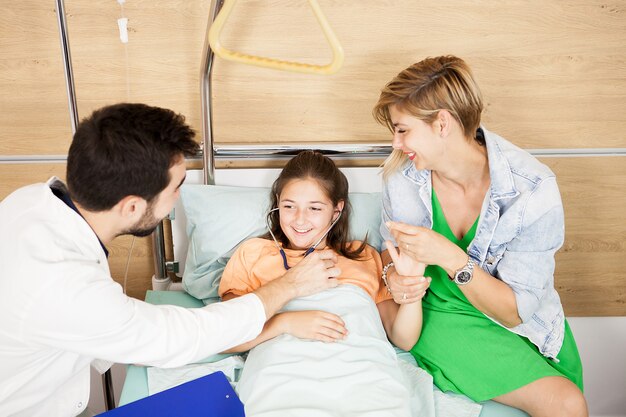 Doctor checking her patient heart  in hospital