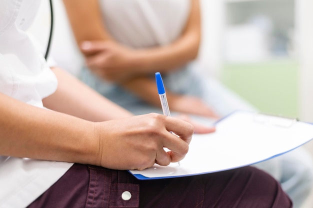 Doctor checking medical form with patient