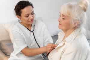 Free photo doctor checking a patient's heart