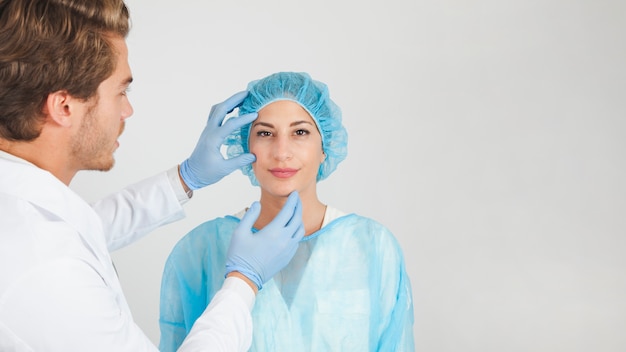 Doctor checking patient with cap