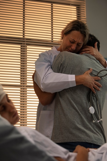 Free photo doctor comforting a friend of her patient