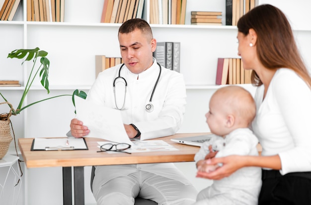 Doctor consulting new born baby