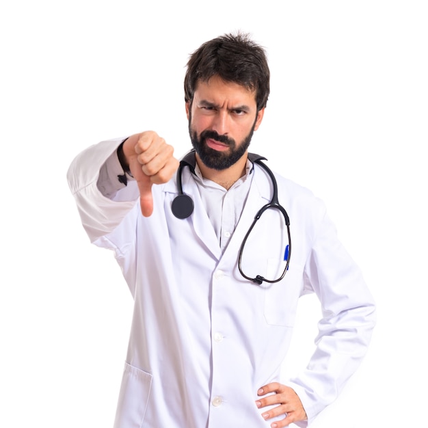Doctor doing a bad signal over white background
