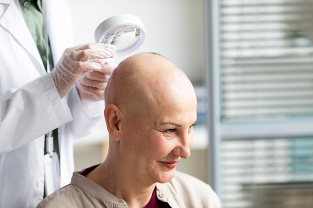 Free photo doctor doing a check on a patient with skin cancer