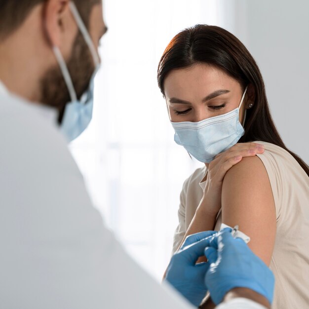 Doctor doing a vaccine to a patient