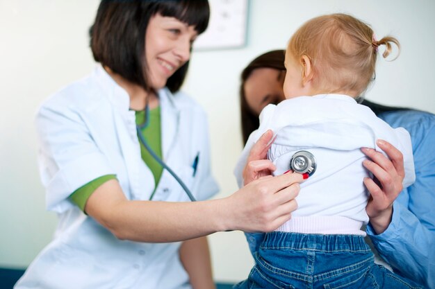 Doctor examining a little girl