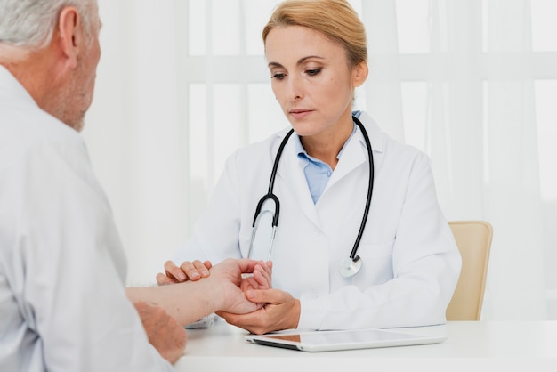 Doctor examining patient hand