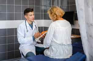 Free photo doctor explaining bone joints to a patient