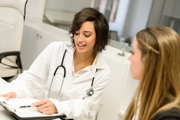 Doctor explaining something to a woman