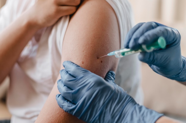 Doctor giving child a vaccine while wearing gloves