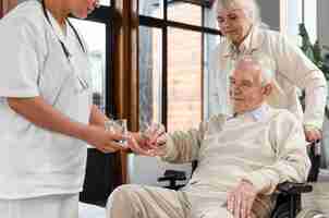 Free photo doctor giving pills to her patient