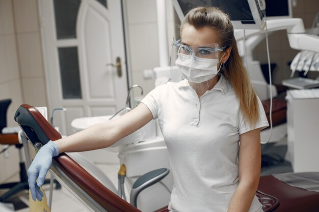 Doctor in goggles.Woman looking at the camera.Dentist is waiting for the patient