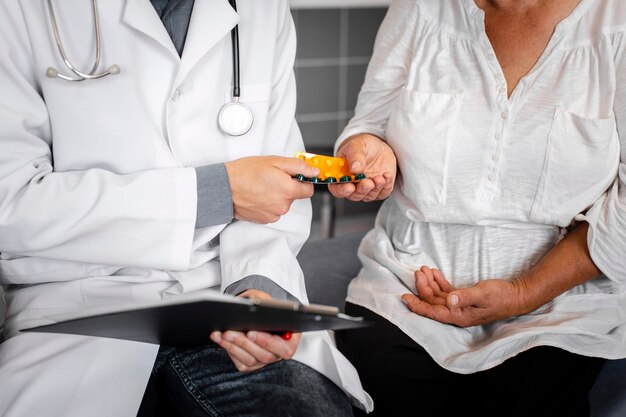 Doctor hands giving pills to patient