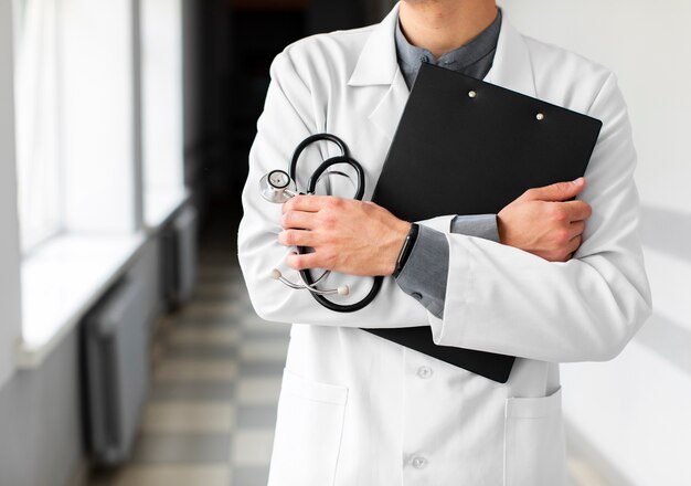 Doctor hands holding clipboard and stethoscope