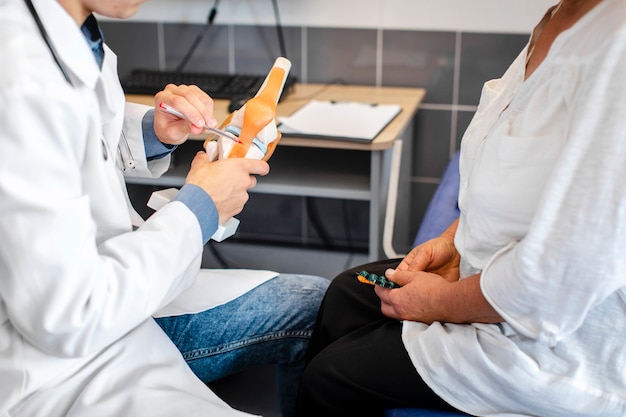 Doctor hands showing bone joints to a patient