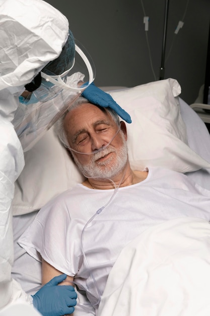 Doctor helping an old man at the hospital