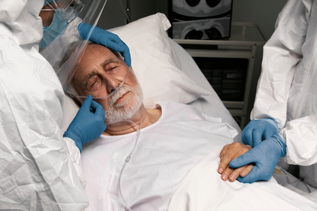 Doctor helping an old man at the hospital