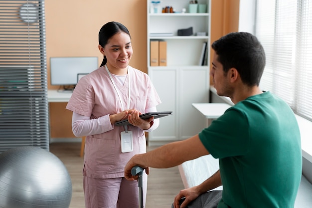 Doctor helping patient during rehabilitation