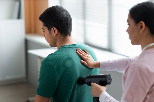 Doctor helping patient during rehabilitation