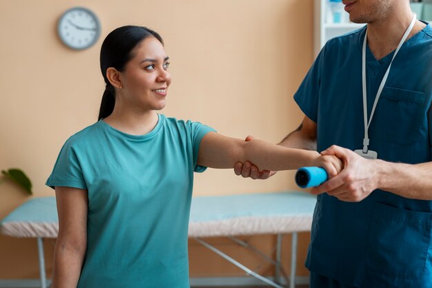Doctor helping patient during rehabilitation