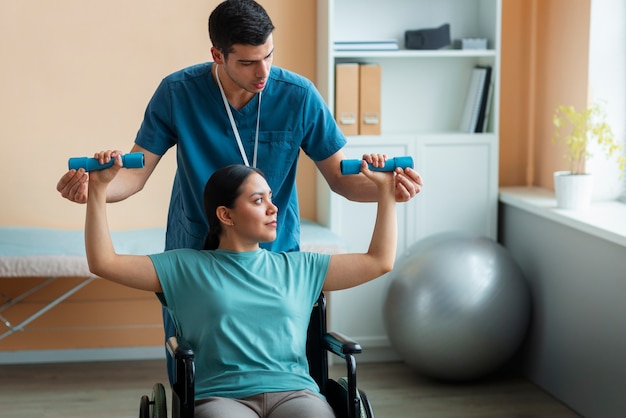 Doctor helping patient during rehabilitation