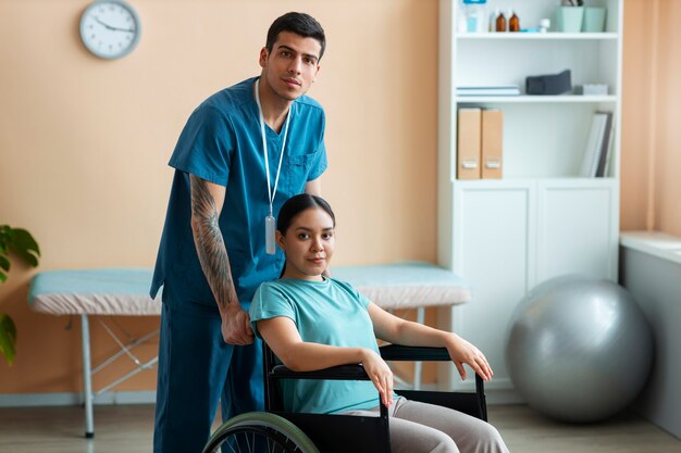 Doctor helping patient during rehabilitation