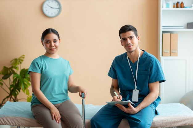 Doctor helping patient during rehabilitation