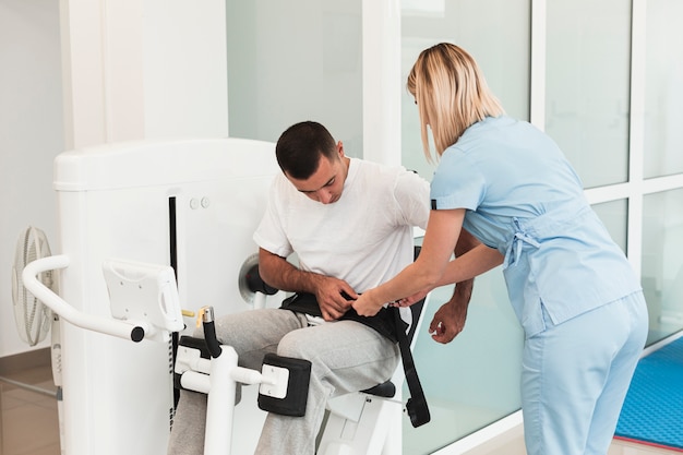 Doctor helping patient to use medical device