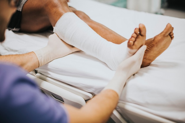 Doctor helping a patient with a fractured leg