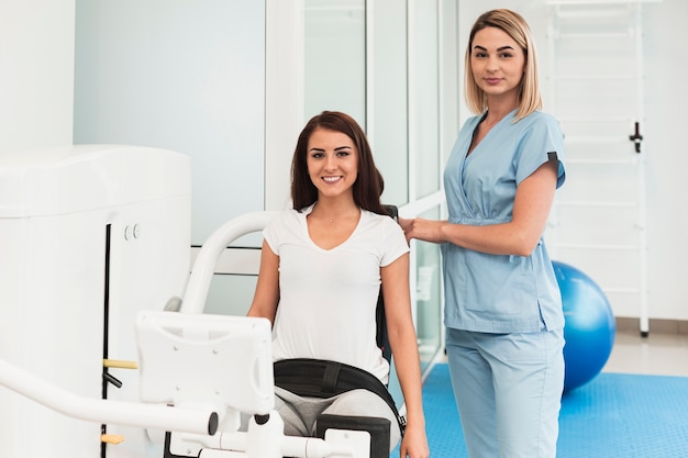 Doctor helping woman with medical device