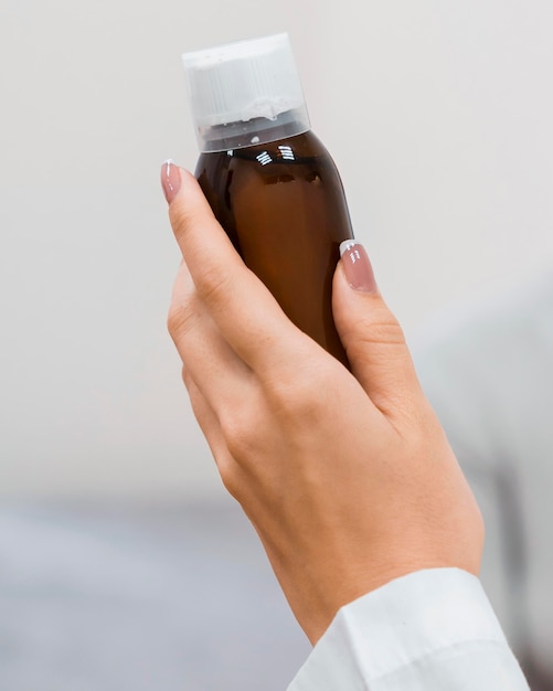 Free photo doctor holding a bottle of medicine