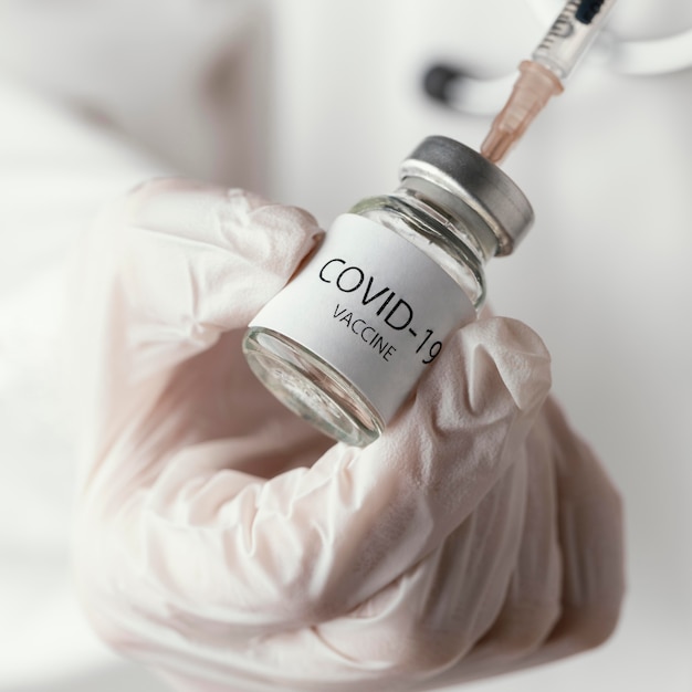 Doctor holding a covid-19 vaccine bottle
