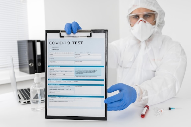 Free photo doctor holding covid test form