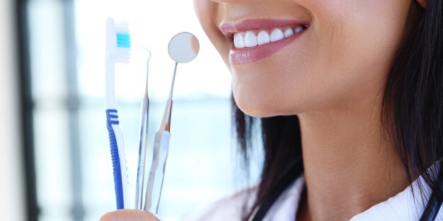 Doctor holding dentist's tools