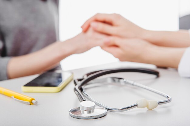 Free Photo doctor holding hands with patient