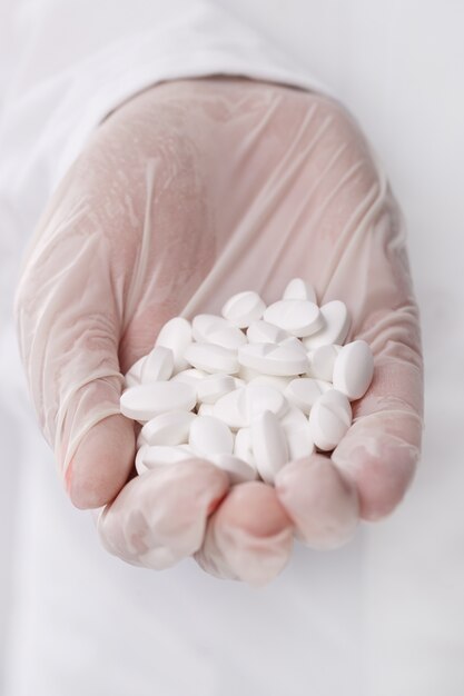 Doctor holding heap of pills