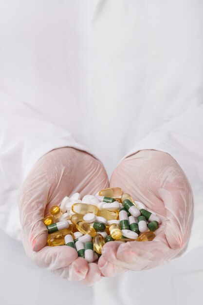 Doctor holding heap of pills