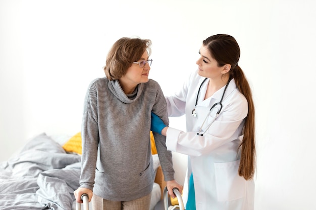 Free photo doctor holding patient medium shot