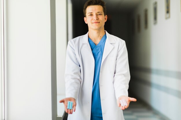 Doctor holding pills in hand