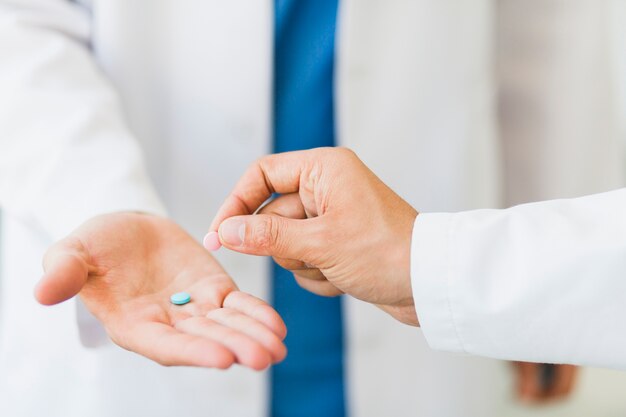 Doctor holding pills