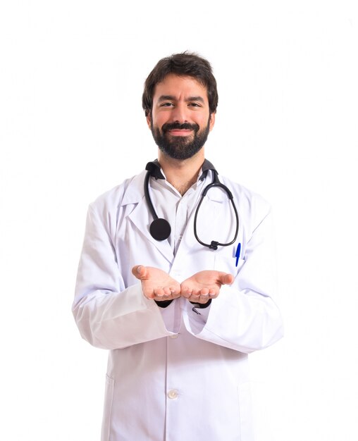 Doctor holding something over white background