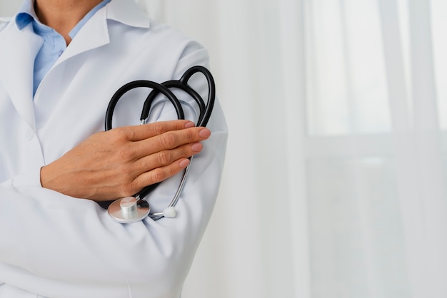 Free photo doctor holding stethoscope on arm